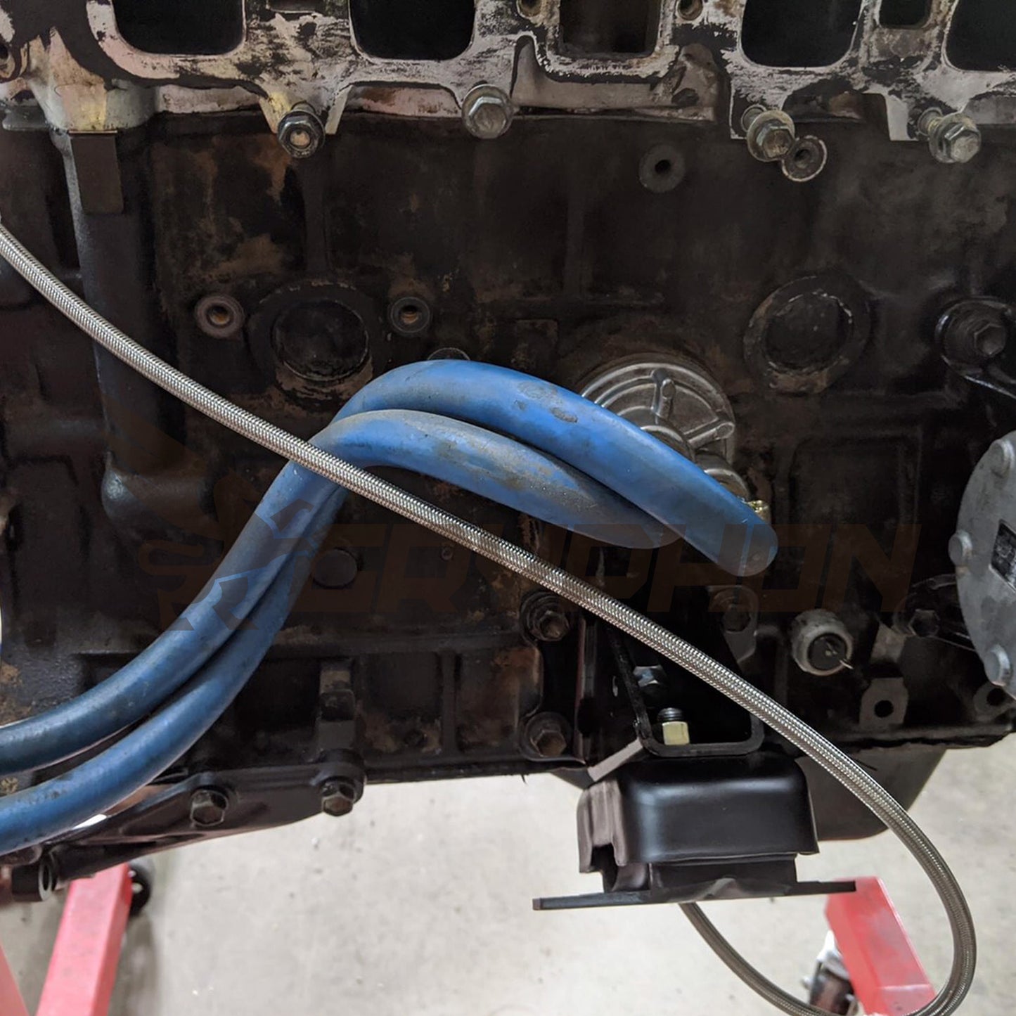 Close-up of PTFE braided oil feed line and fittings for Toyota 22R 22RE