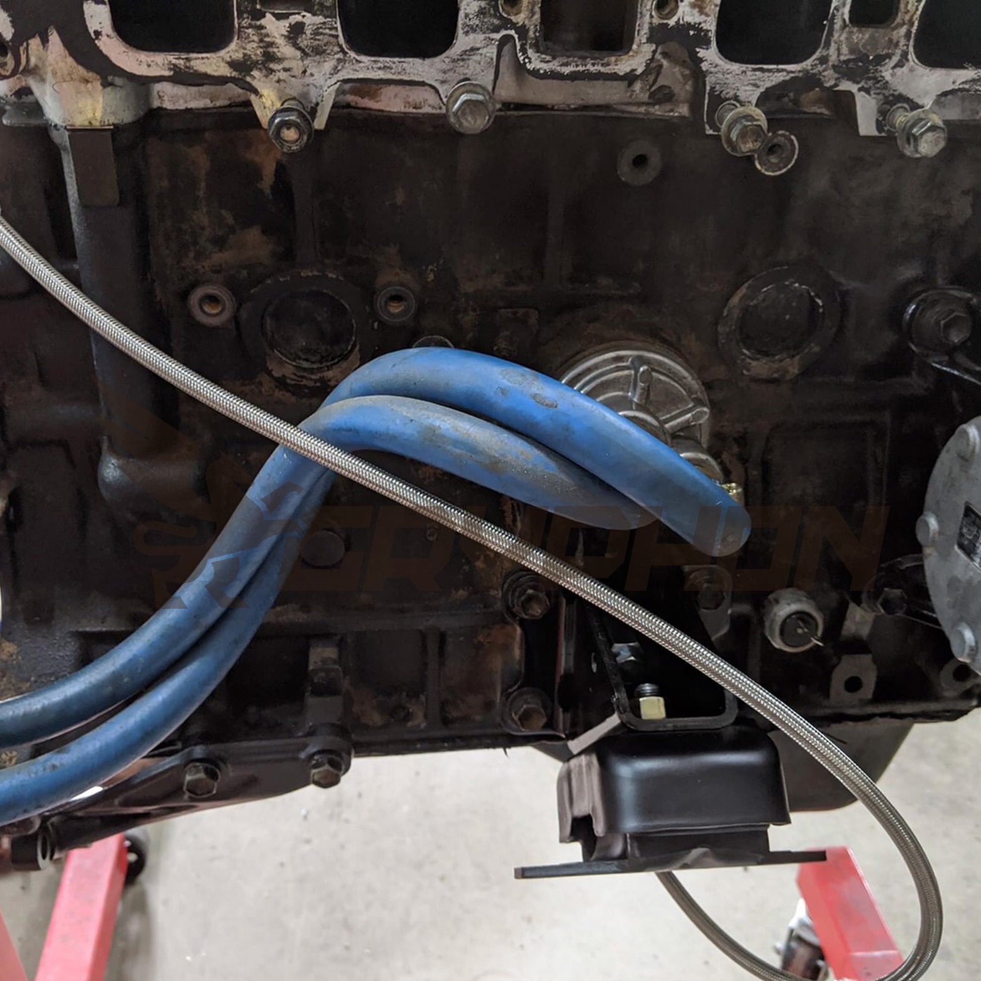 Close-up of PTFE braided oil feed line and fittings for Toyota 22R 22RE