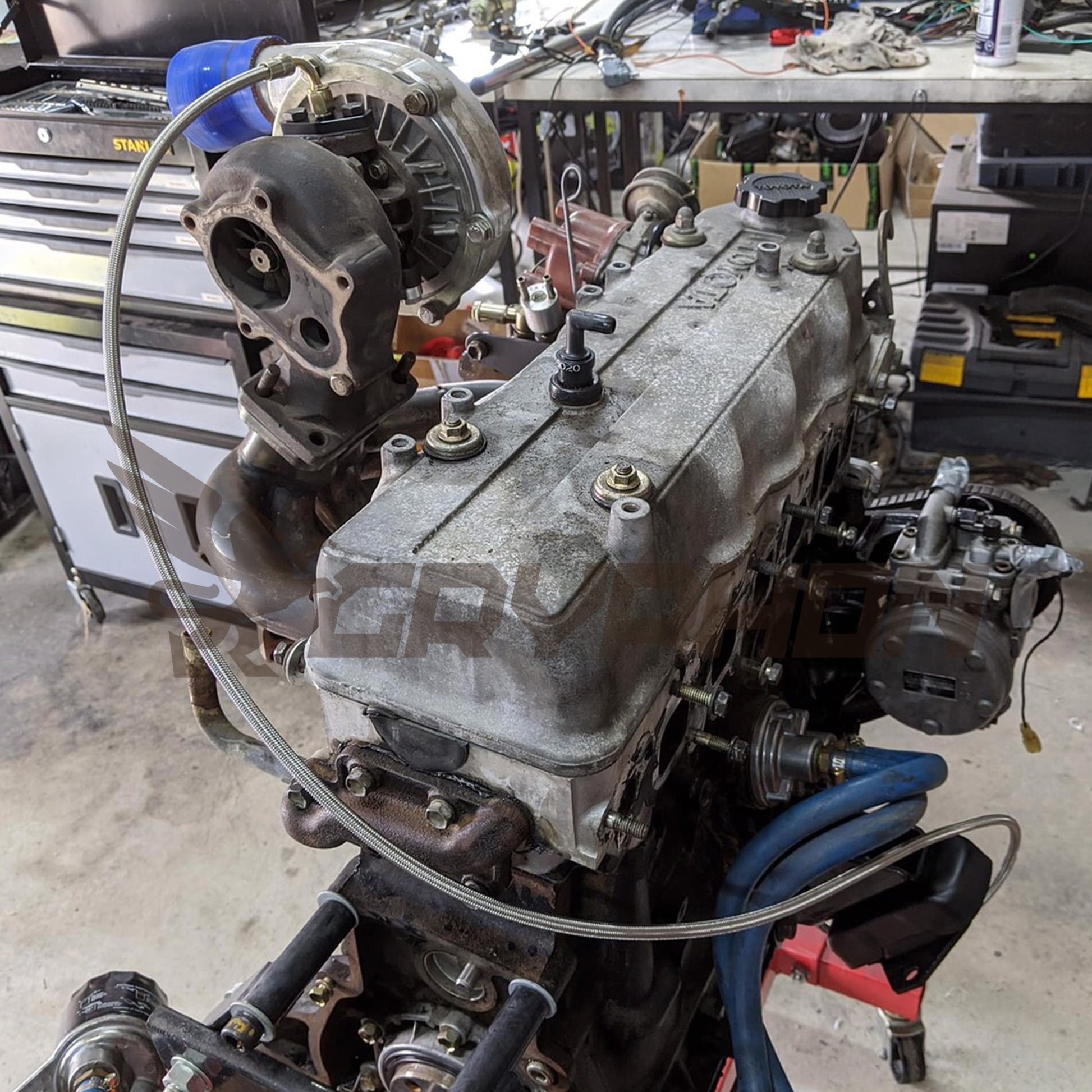 Braided 4AN turbo oil feed line routing from engine block to Garrett T3 T4 turbocharger on Toyota 22R/22RE