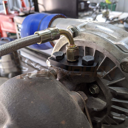 Garrett T3 T4 turbo oil feed flange with 2.0mm restrictor installed on Toyota 22RE